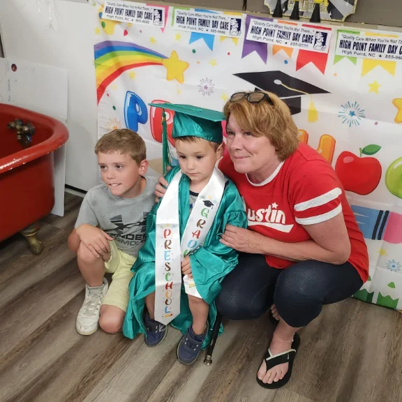 Teacher celebrating with a preschool graduate